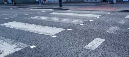 Striped road markings on a Zebra Crossing