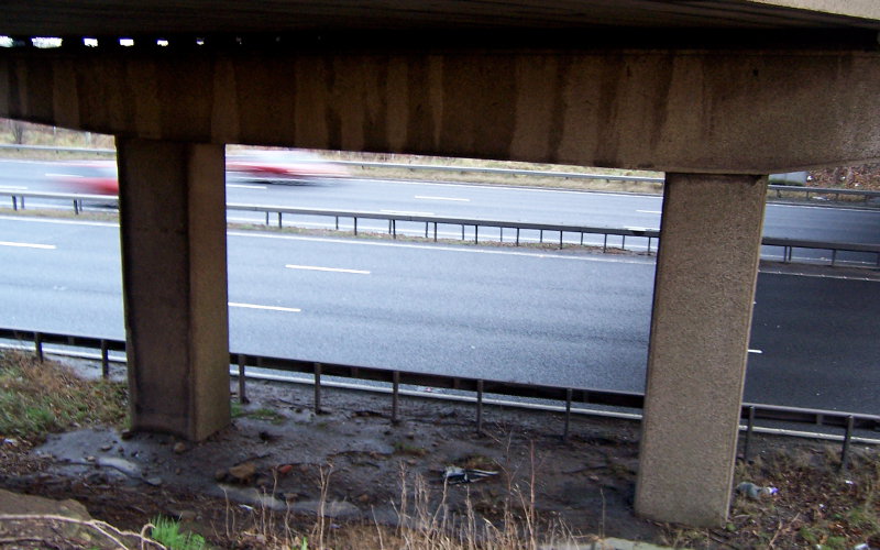 Down below, the supports are horizontal beams balanced on pairs of chunky concrete legs - the same design as all the other original overbridges, all now gone.