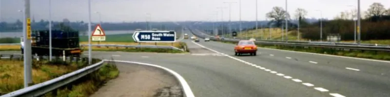 The astonishingly sharp exit to the 270-degree loop, after the junction had fully opened to traffic. Its warning signs have advisory speed plates. Click to enlarge 