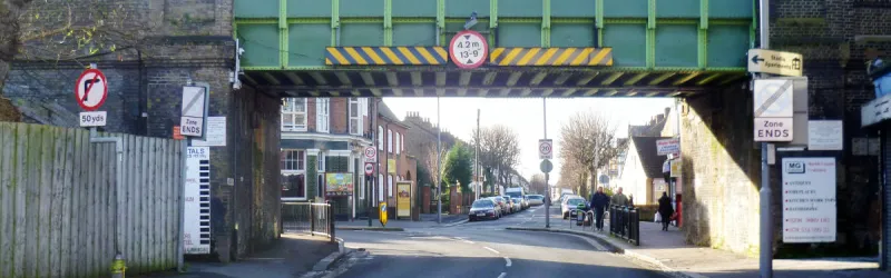 The A106 Grove Green Road ducks under a railway and turns a sharp corner. This was the substandard road that Radial Route 7 would replace. Click to enlarge