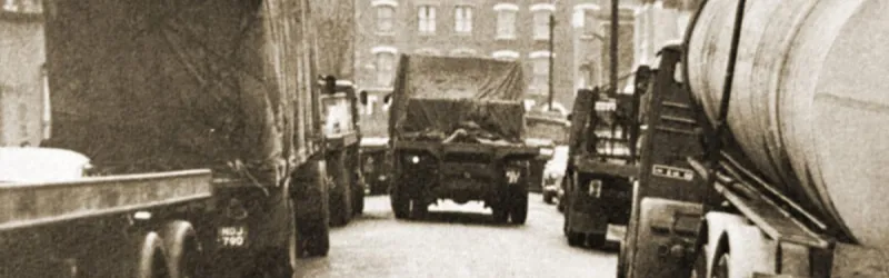 Heavy traffic negotiates East London streets to reach the docks in the mid-1960s. Click to enlarge