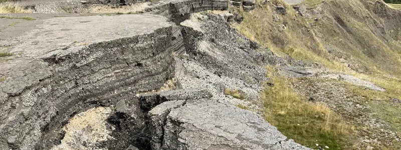 Layer upon layer of tarmac crumbles into the valley. Click to enlarge