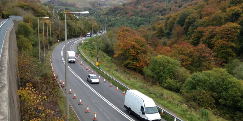 The Heads of the Valleys Road in the Clydach Gorge, running on a ledge cut from the rock. Note the huge retaining wall to the left. Click to enlarge
