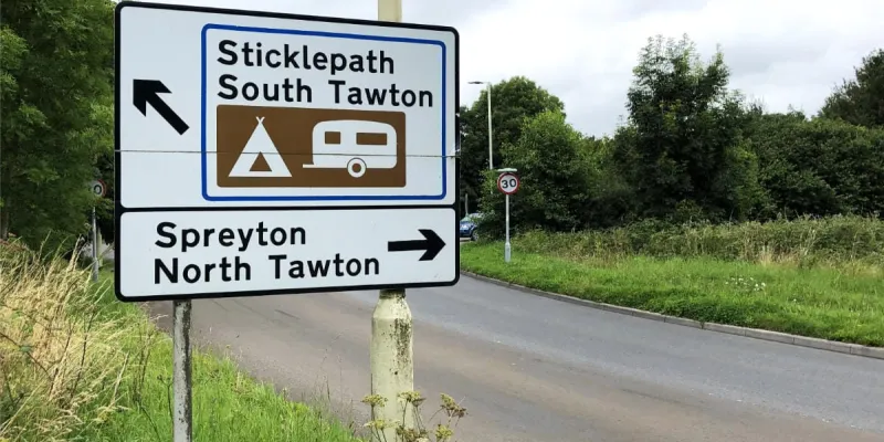 A brown tourist panel inside a blue bordered panel on a black and white sign, like the circles that you find in the windmills of your mind. Click to enlarge