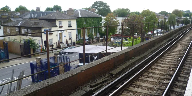 Blenheim Grove, south of Peckham Rye station, seen from the platform. The South Cross Route would have obliterated everything seen here beyond the railings. Number 9 is the cream-coloured house. Click to enlarge