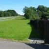 Looking south again in the third photograph one can just make out the bus stop by the fence of the house. This would have originally been located in a small layby as buses used to stop on the A74. The road was littered with signs warning of buses stopping on the carriageway. Remember, this road was effectively a motorway before! Quite strange that they haven't bothered to move the bus stop since they removed the carriageway.