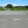 In this photograph, the lane markings of the old carriageway can be seen. The dashed markings closest to the photographer were the old sliproad/junction edge markings. The next set of lines are the centre line, and the lines after that are the old lines to indicate the edge of the right-turn gap in the central reservation. Beyond that are the accompanying right-turn lane markings for the southbound carriageway.