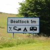 And here's the sign close up. It really is huge. One can tell it's from the A74 era, as it has a blue border for local destinations. The blue and black border distinctions were scrapped before this section was bypassed, so the sign is from the A74.