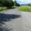 Part of the old northbound carriageway has been kept along this stretch to be used as the a cycle path. At this driveway entrance the road shows through really well. One can pick out catseyes and lane markings quite easily.