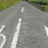 Facing the other way for a moment the old junction edge markings can be seen underneath the current cycle path markings, along with the taper for the exit road from the carriageway.
