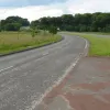 Taking a few steps to the left reveals the former A74 climbing up a hill and over a bridge. It is strange to think that this is once what the main north-south road out of Scotland looked like.