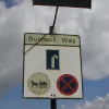 A sliproad joins eastbound from this flyover, and has what looks like an original restrictions sign. These appear at all entrances, including the entry points to the roundabout midway. Presumably horse drawn vehicles are required to turn around in the middle of the road there.