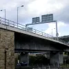 The roundabout itself is built into the hillside, and immediately to the east the land drops steeply away. The next section of Burdock Way lifts off (on some sandstone-clad retaining walls) and mounts the viaducts across the valley.