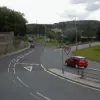 The junction at the eastern end is effectively a roundabout, but it is sited on a steep hillside and the viaducts join and leave in unusual places. Here the Give Way sign is visible - in fact, both lanes can be used for the A58, but only the right hand one must give way to the roundabout.