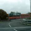 We begin our more-than-comprehensive tour at junction 2. We've just left the roundabout at junction 1, and this is the off-slip dropping down under the mainline. Are those signs for us?