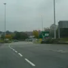 Oh no! Suddenly there's two more lanes on the right and a roundabout in about ten seconds' time. Anyone wishing to turn right at this roundabout would need nerves of steel in the rush hour. Luckily, it's not too busy, so we'll loop around and go back on.