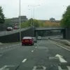 A slightly motion blurred photo showing the approach to the junction 6 underpass. Notice the unusually tall streetlights — they're tall enough for traffic on the sliproad, but serve the mainline as well.