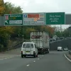 A steep sliproad climbs to the A4114 for Birmingham, while a small cluster of unreadable LEDs inform drivers to watch their speed and that there's spaces at Leigh Mills car park. Watch the lorry.