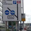 Further south, and now approaching the daring underpass. Once a diamond junction open to all traffic, it's now heavily restricted in certain places. The southbound off-slip is two lanes wide; today one is for trams and the other for buses. The other three sliproads are open to all traffic. The direction signage reading "All routes use underpass" is non-standard and quite strange.