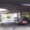 Looking south, underneath the flyover on Wandle Road. This street is lined with terraced houses on both sides, but there is a huge gap in the middle where the whole street is effectively roofed over by the flyover, a sliproad on each side heading for the Duppas Hill Roundabout, and at the far side, a looped entry point directly from the flyover to the multi-storey car park.