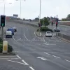 Another look at the Rectory Grove junction. To the right was the corresponding entry and exit for the southbound side. Ahead, there's an odd swerve in the three forward lanes, where it's obvious they have been moved left to incorporate a right-turn lane. The left lane is now in the space that used to be an acceleration lane from Rectory Grove. (It still has a smaller streetlight over it that would have made more sense when it was not above the main carriageway.)
