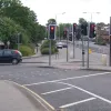 The entry and exit on the southbound side, once free-flowing and now controlled by a forest of traffic lights.Through the middle of the triangular island, traffic can enter the side road having turned through a gap in the central reserve, but the opposite movement isn't possible.