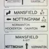 A prime example of the inefficient use the old-style signs made of space. The top example is mostly empty space, and the stacked examples below achieve two to three times the letter height on destinations with no extra sign space.