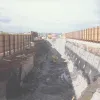 The excavation for phase 2 of construction of the M1 Tunnel. This phase was constructed in a temporarily widened central reserve whilst maintaining 3 lanes of traffic in each direction. This photograph shows rock anchoring work in progress. Photograph taken 11 March 1998.