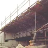 Shows the underside of the support system used to cast the deck edge for the parapet of the M62 bridge.