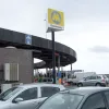 Both tunnels are maintained and operated by Merseytravel, the Public Transport Executive for the Liverpool region. It is treated as though it were any other Merseytravel facility, and gets this tall signpost in the toll plaza, the same as the ones posted at the entrances to train stations. The toll booths each have a "Queensway" sign on them, which are the correct dimensions, layout and typeface to be the placename signs found on station platforms.
