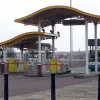 If you exit the tunnel and turn a hard left to head northbound along the riverside, you'll exit through a different, smaller toll plaza. It's quite enthusiastically out of keeping with the rest of the tunnel mouth area, and would probably be more in keeping with a refurbished motorway service area.