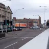 Turning to face the other way, immediately on exiting the underpass traffic stops at these traffic lights. When it first opened the barrier to the right continued as a central reservation right through the junction, with the road to the left merging in. It has since been opened up and signalised to allow access to industrial areas to the right.