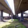 Underneath the two parallel flyovers that run to the south of the marshalling areas. To the left is a two-way flyover, the A5227. To the right is a two-lane, one-way flyover carrying traffic exiting the tunnel. Straight ahead, all its traffic now joins the A552 west. The stub to the right is all that remains of the flyover demolished in the early 1990s, replaced by the roundabout above.