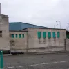 The decorative flair is very much in evidence here too. The entrance pillars seem to be topped with chimneys, but these are unlikely to be functional. It's possible that they were once topped with lights. It is not clear whether the green-painted panels to the right were windows and if this was actually a service building of some kind.