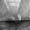 February, 1931: the full circle of the tunnel, awaiting its road deck, looking from Birkenhead towards Liverpool. It's not clear what the suspended wooden structure at the top is for; it may simply have kept cables and pipes out of the way.