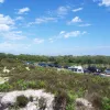 The surrounding landscape is mainly sand dunes, many of them covered in grass or scrub. The ferry company has not exercised its right to fence the road in, and so you can walk to the beaches very easily.