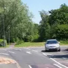 At Crab Lane, the road ends. Immediately to the right is College Place roundabout on Birchwood Way. However, look carefully and you can see the road used to continue over - the footpath gives the game away.