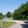 Another hundred yards or so, and a street emerges from the housing estate in Locking Stumps just to the north and turns to become the old A574 again. From here the houses' addresses are "Warrington Road" and are numbered in the 700s.