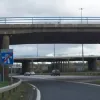 The end of the motorway and the start of the shockingly brief merge area. The rows of thin little stalks that the flyover is supported by over there are quite remarkable..