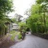 Shortly afterwards we find ourselves swooping through the woods, and in many places from here to Brecon the road doesn't look much like a trunk route. Here, it is too narrow to have a centre line for a while as we pass between a farm building and a high wall.
