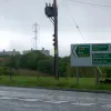 We're on our way out of the National Park now. Before we leave, the buildings in the distance are part of Trawsfynydd Nuclear Power Plant. As you can see, we've come to another Give Way line, and we turn left again, joining what used to be the A487 — and still is, to the right.