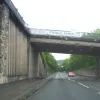 In between them we run up close to the town itself, providing a surprisingly urban bit of road, rubbing up against this chunky concrete retaining wall. Don't worry; it won't last long.