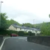 As the road settles into the valley, it rubs up alongside a railway line and finds itself pasing under and over it several times — often narrowing down to one lane in order to get through. This bridge crosses the river at Commins Coch, and is on the lengthy section of road borrowed from the A489.