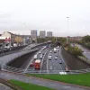 Looking north from the footbridge near Sauchiehall Street, the M8 emerges from a tunnel two levels beneath us and curves east. Braided sliproads are visible to the left.