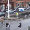 An engineer inspects the motorway signal, in what is otherwise a very urban setting.