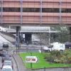 This office building is actually built on a structure that was intended to be a road bridge, which sat empty for many years. It was known as the "bridge to nowhere" locally, as it spanned the motorway and immediately stopped to both sides. Today it helps to break up the view of the motorway.