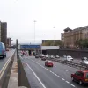 A look south from the same location shows "the canyon". At this point the motorway is at a high point in the cutting; to both sides it falls away. The reason is that it is crossing a sub-surface railway and has to rise a little way in order to clear it.