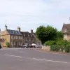 At the village main street, there's a give way line and the A-road turns right. To the left is the B671 to Elton.