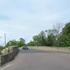 The main street narrows suddenly, rising up to the level of the Nene Bridge.