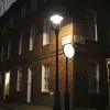 On the corner of Gayfere Street, this gas lamp stands next to a modern "no entry" sign which is internally illuminated with white LEDs. It's much brighter than the street light and probably not a very good choice for this setting.